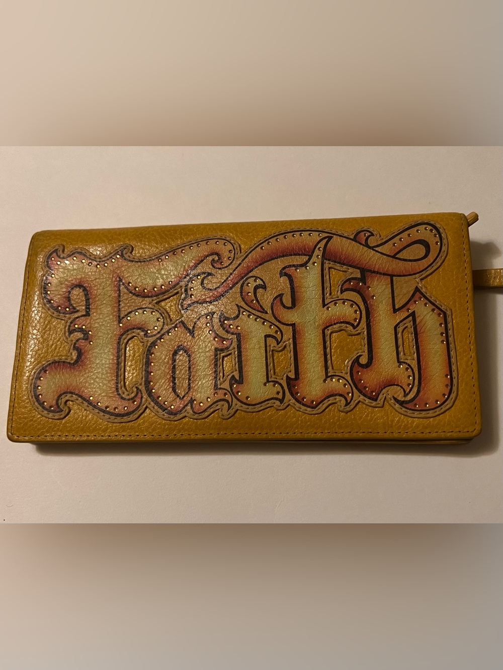 Isabella Fiore - “FAITH” 
Graphic Script Leather Wallet in Mustard Yellow